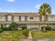 Charming townhome featuring a well-manicured lawn and a welcoming front entrance with seating at 1225 Coral Coast Dr, Orlando, FL 32824