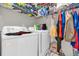 Convenient laundry area featuring a washer, dryer, and shelving for storage at 1225 Coral Coast Dr, Orlando, FL 32824