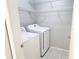 Convenient laundry room equipped with washer, dryer, and wire shelving at 1225 Coral Coast Dr, Orlando, FL 32824