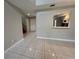 Open living area with tile floors, views to the kitchen, and front entrance at 1225 Coral Coast Dr, Orlando, FL 32824