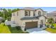 Well-maintained home with a two-car garage, manicured lawn and inviting landscaping at 178 Forest View Dr, Davenport, FL 33896