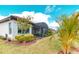 Backyard featuring a screened-in lanai, professional landscaping, and a well-maintained lawn at 3704 Via Monte Napoleone Dr, Poinciana, FL 34759