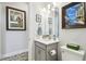 A well-lit bathroom with gray vanity, and decorative art at 3704 Via Monte Napoleone Dr, Poinciana, FL 34759