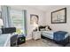 A cozy bedroom with a twin bed, desk, and window at 3704 Via Monte Napoleone Dr, Poinciana, FL 34759