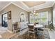 Dining area featuring a round table, shuttered windows, and a stylish buffet with a mirror at 3704 Via Monte Napoleone Dr, Poinciana, FL 34759