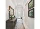 Elegant hallway with tray ceilings, decorative mirror, and stylish console table at 3704 Via Monte Napoleone Dr, Poinciana, FL 34759