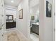 A bright hallway, showing a bathroom at 3704 Via Monte Napoleone Dr, Poinciana, FL 34759