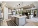 Open concept kitchen and living room with gray cabinets, stainless appliances, and a center island at 3704 Via Monte Napoleone Dr, Poinciana, FL 34759