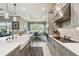 Kitchen with gray cabinets, an island with white countertop and stainless appliances at 3704 Via Monte Napoleone Dr, Poinciana, FL 34759