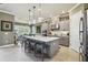Bright and spacious kitchen with a large central island and bar seating overlooking the dining area at 3704 Via Monte Napoleone Dr, Poinciana, FL 34759