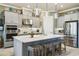 A spacious kitchen featuring a large island with seating, stainless steel appliances, and modern countertops at 3704 Via Monte Napoleone Dr, Poinciana, FL 34759