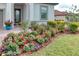 Beautiful landscaping featuring flower garden with mulch and numerous colors and textures at 3704 Via Monte Napoleone Dr, Poinciana, FL 34759