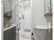 Laundry room with gray cabinetry, a utility sink, and stainless steel washer and dryer at 3704 Via Monte Napoleone Dr, Poinciana, FL 34759
