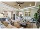Cozy living room with plush seating, neutral decor, and open layout to the kitchen at 3704 Via Monte Napoleone Dr, Poinciana, FL 34759