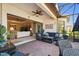 Inviting covered patio with brick pavers and comfortable seating, seamlessly flowing into the living room at 3704 Via Monte Napoleone Dr, Poinciana, FL 34759