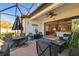Relaxing covered patio features a dining area, lounge chairs and seamless indoor outdoor living at 3704 Via Monte Napoleone Dr, Poinciana, FL 34759