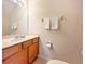 Cozy bathroom featuring a single sink vanity with a toilet and a towel rack at 423 Corvina Dr, Davenport, FL 33897