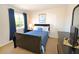 Bedroom featuring a large window, navy bedding, and dark wood furniture at 423 Corvina Dr, Davenport, FL 33897
