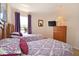 Bright bedroom with two beds, view of the neighborhood, TV and light brown dresser at 423 Corvina Dr, Davenport, FL 33897