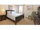 Bedroom with carpet floors, dark wood furniture, and a bright window at 423 Corvina Dr, Davenport, FL 33897