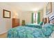 Charming bedroom with two beds, dresser, mirror and view to the outside at 423 Corvina Dr, Davenport, FL 33897