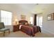Serene main bedroom retreat with a king-sized bed, en-suite bathroom, and a peaceful ambiance, perfect for rest and relaxation at 423 Corvina Dr, Davenport, FL 33897