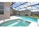 Relaxing pool and spa with a pool safety guideline sign and screened-in enclosure at 423 Corvina Dr, Davenport, FL 33897