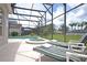 Relaxing pool and spa with lounge chairs and screened-in enclosure at 423 Corvina Dr, Davenport, FL 33897