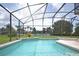 Refreshing pool with spa and screened-in enclosure and well kept landscaping at 423 Corvina Dr, Davenport, FL 33897