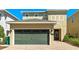 Inviting home featuring a two-car garage and brick driveway leading to a welcoming front entrance at 7556 Marker Ave, Kissimmee, FL 34747