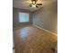 A bedroom offering tile floors, a ceiling fan, and a large window for natural light at 5226 Via Hacienda Cir # A314, Orlando, FL 32839