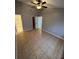 Bright bedroom features a ceiling fan, tile flooring, and neutral colors at 5226 Via Hacienda Cir # A314, Orlando, FL 32839