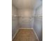 Spacious walk-in closet featuring neutral paint, wire shelves, and tile flooring at 5226 Via Hacienda Cir # A314, Orlando, FL 32839