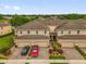 Aerial view of townhomes with garages and landscaping at 1031 Wood Cv, Kissimmee, FL 34743