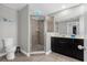 Modern bathroom with walk-in shower, decorative mirror, and tiled floors at 1031 Wood Cv, Kissimmee, FL 34743