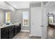 Bathroom with double vanity features a window and view into the bedroom at 1031 Wood Cv, Kissimmee, FL 34743