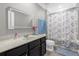 Spacious bathroom with vanity, mirror, and butterfly-themed shower curtain at 1031 Wood Cv, Kissimmee, FL 34743