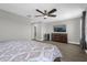 Large bedroom with a ceiling fan features wood-look floors and modern decor at 1031 Wood Cv, Kissimmee, FL 34743