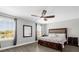 Bright bedroom with wood-look floors features a ceiling fan and backyard views at 1031 Wood Cv, Kissimmee, FL 34743