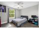 This bedroom includes a ceiling fan, a closet and a window offering a view of the outdoors at 1031 Wood Cv, Kissimmee, FL 34743