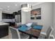 Elegant dining area adjacent to the kitchen, featuring modern decor and ample natural light at 1031 Wood Cv, Kissimmee, FL 34743
