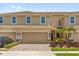 Inviting two-story townhome featuring a two-car garage and well-maintained landscaping at 1031 Wood Cv, Kissimmee, FL 34743