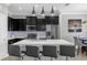 Contemporary kitchen featuring stainless appliances, dark cabinetry, and an island with seating at 1031 Wood Cv, Kissimmee, FL 34743