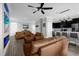 Open-concept living space featuring a fireplace, modern furniture, and seamless kitchen access at 1031 Wood Cv, Kissimmee, FL 34743