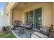Relax on the patio with a BBQ grill, comfortable seating and a view of the lake at 1031 Wood Cv, Kissimmee, FL 34743