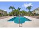 Community pool with a sunny patio and palm trees at 1031 Wood Cv, Kissimmee, FL 34743