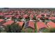 Expansive aerial view of a community with red-tiled roofs and well-maintained landscaping at 1102 Solana Cir, Davenport, FL 33897
