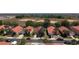 Aerial shot of a neighborhood featuring well-maintained homes with red tile roofs and lush landscaping at 1102 Solana Cir, Davenport, FL 33897