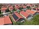 Aerial view of homes with solar panels and screened-in pools in a well-maintained neighborhood at 1102 Solana Cir, Davenport, FL 33897
