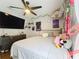 Bright bedroom with a ceiling fan, comfortable bed, and playful decor, creating a cozy and inviting retreat at 1102 Solana Cir, Davenport, FL 33897